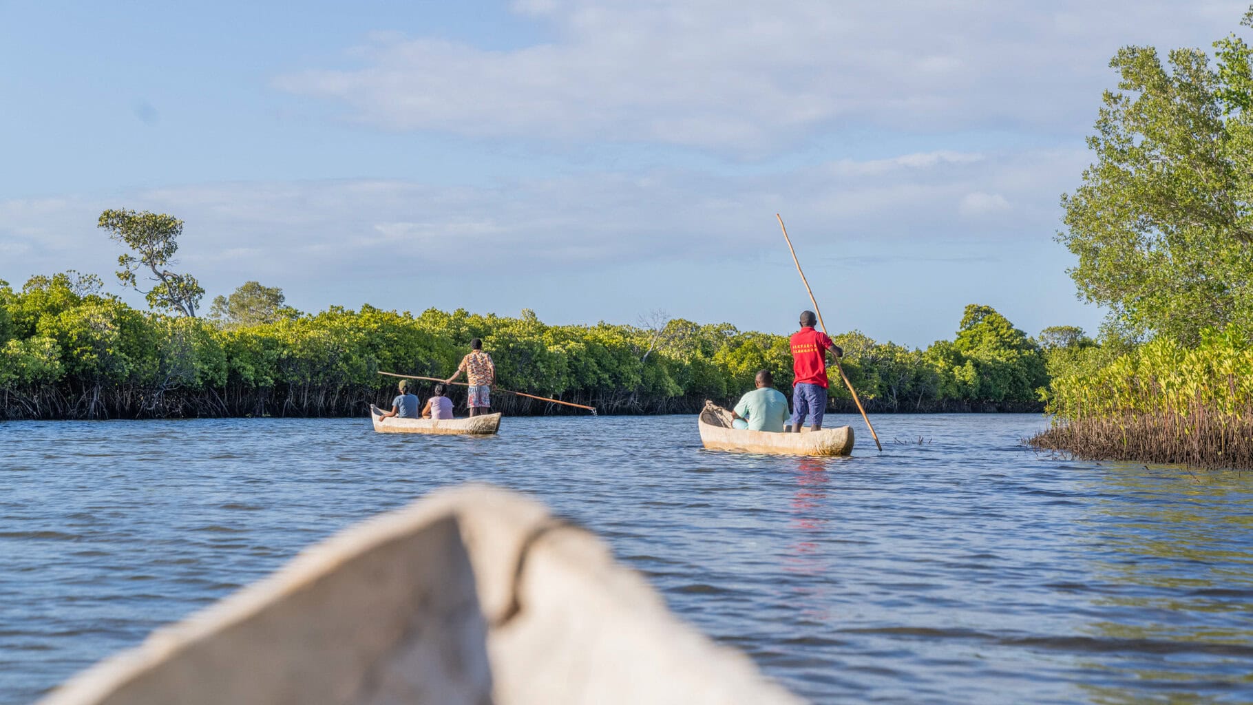 Guests going out with guides in two  traditional dugout canoes with Miavana Madagascar