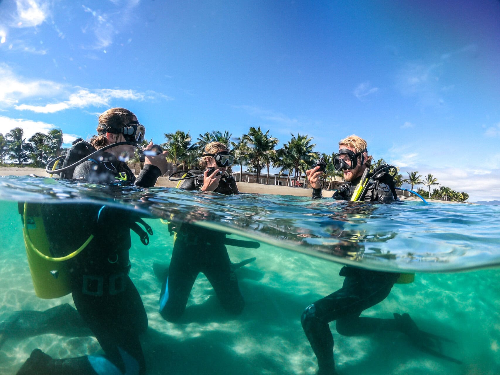 Two guests and their instructor learning to scuba dive at Miavana by Time + Tide Madagascar