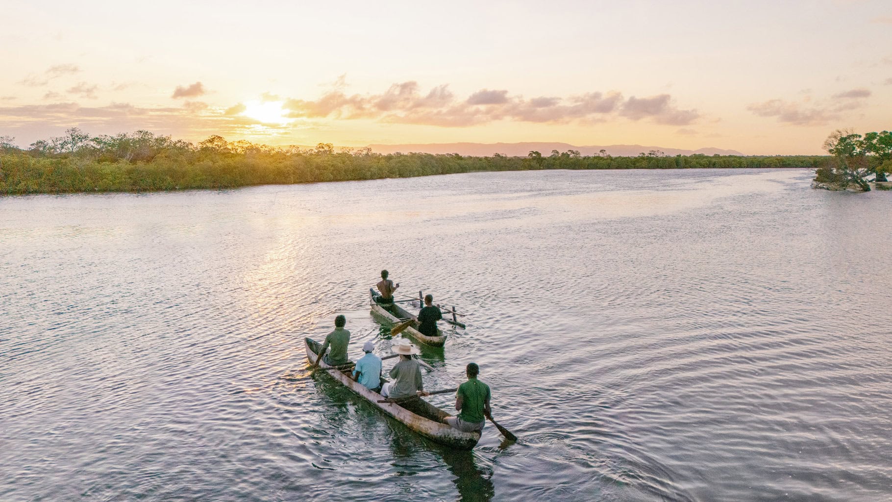 Guests on a mangrove cruise in traditional dugout canoes Miavana, Madagascar